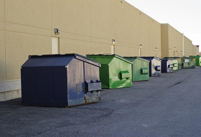 bright yellow construction dumpster full of discarded materials in Baldwin City